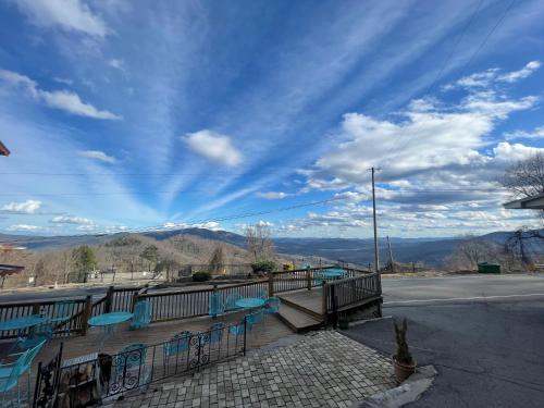 a view of the mountains from a balcony with benches at Skyline Village Inn in Spruce Pine
