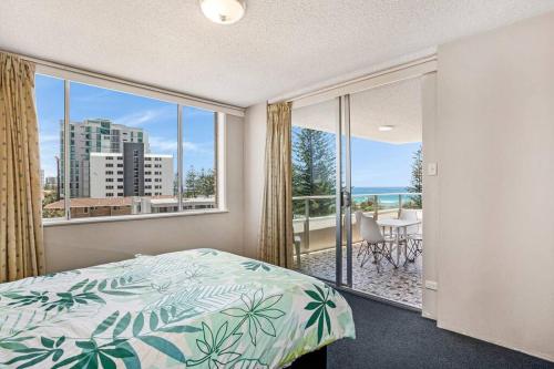 a bedroom with a bed and a large window at Wyuna - Walking distance to burleigh in Gold Coast