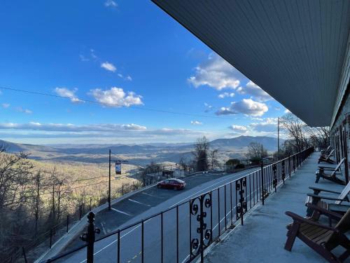 a balcony with a car driving down a road at Skyline Village Inn in Spruce Pine