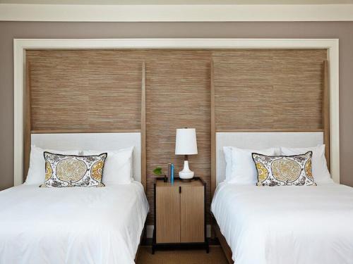two beds sitting next to each other in a bedroom at The Island House in Nassau