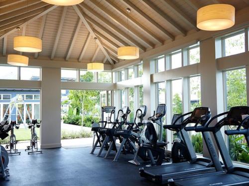 a gym with rows of treadmills and elliptical machines at The Island House in Nassau