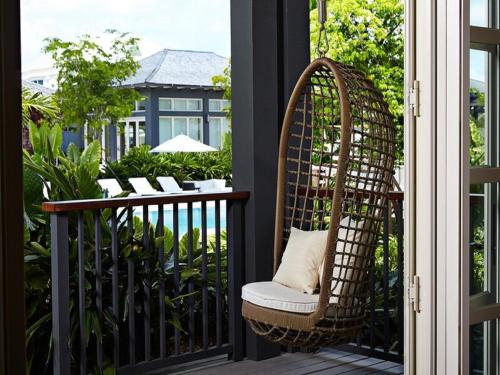 a wicker chair sitting on a balcony at The Island House in Nassau