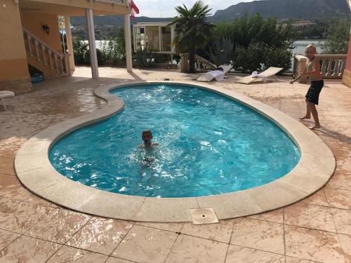 a child swimming in a swimming pool at Ebro Fishing in Mequinenza