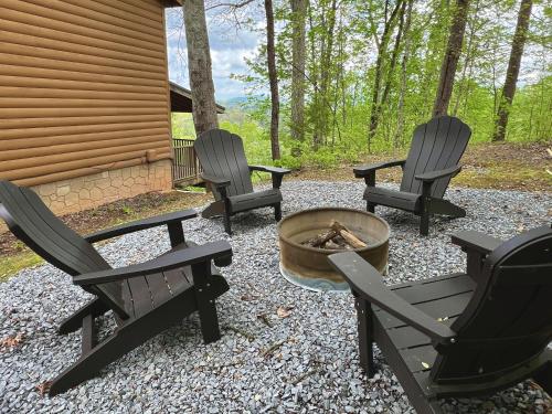 three chairs and a fire pit in a yard at Dolly's # 2 condo in Sevierville