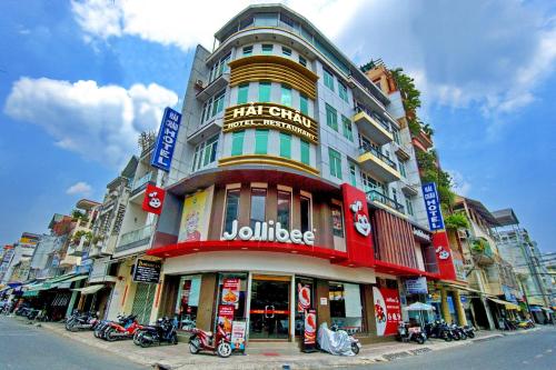 a large building with motorcycles parked in front of it at Hotel Hải Châu in Ấp Phước Thọ