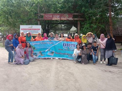a group of people are holding a large check at Madu Tiga Beach and Resort in Tanjung Pinang 