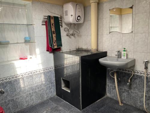a small bathroom with a sink and a sink at Kanjira house in Ooty