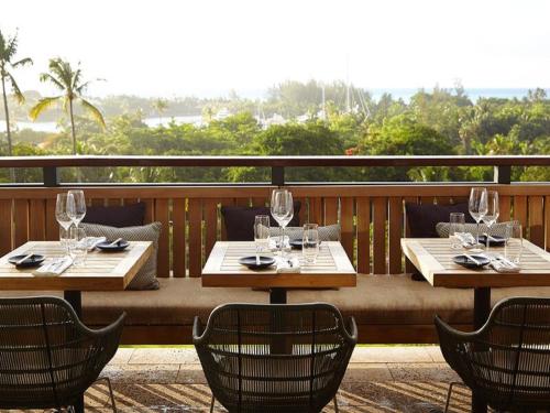 two tables with wine glasses on a balcony at The Island House in Nassau