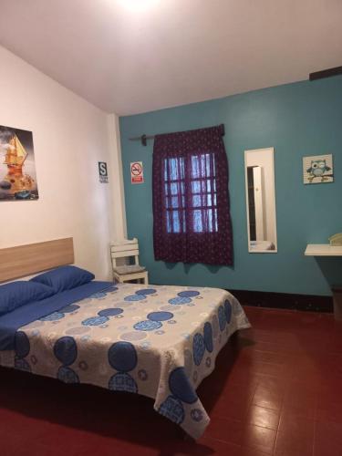 En eller flere senger på et rom på El Boquerón - Hospedaje
