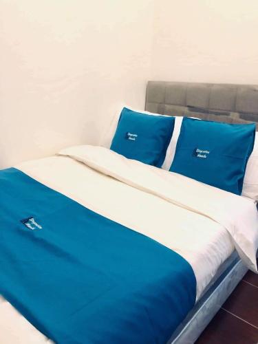 a bed with blue and white sheets and pillows at Kasara Urban Resort 1BR Condo in Manila