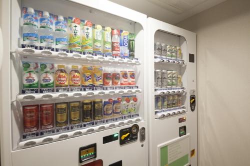a refrigerator filled with lots of bottles of soda at Hotel Sunroute Ginza in Tokyo