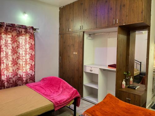 a small room with a bed and a closet at 1 Bedroom & Living Room for Friends & Families in Chāmundi