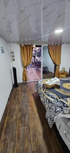 a bedroom with two beds and a wooden floor at Buda House Beach in Playa Blanca