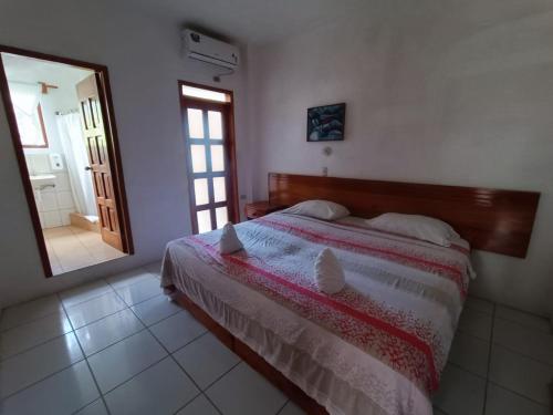 a bedroom with a bed and a large mirror at Galapagos Verde Azul in Puerto Ayora