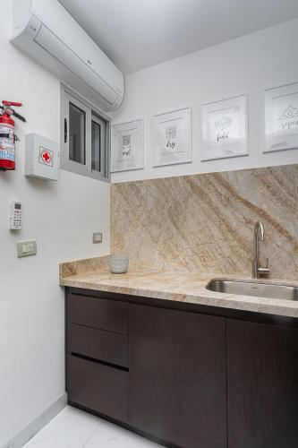 a kitchen with a sink and a counter at Mareazul Beach Front Condos At playa del Carmen in Playa del Carmen