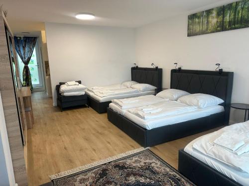 a room with three beds and a rug at Ferienwohnung in Center of Hamburg-Barmbek-Airport-2 in Hamburg