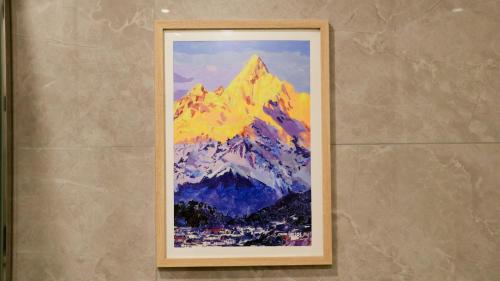 a painting of a mountain on a wall at Joke Inn in Xi'an