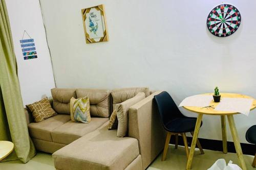 a living room with a couch and a table at Mikocheni Full House - 1 Bedroom in Dar es Salaam
