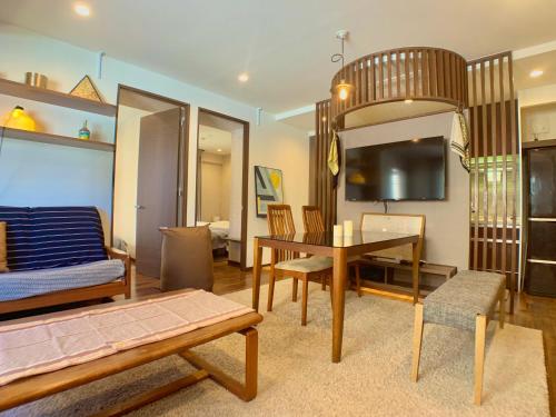 a living room with a table and a bedroom at Kyodo Private House in Tokyo