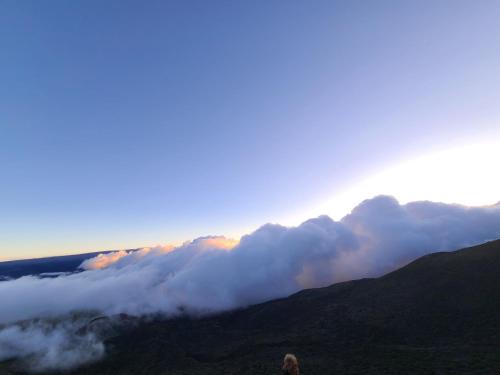 a view of a mountain with clouds in the sky at Paradise Park Newly built studio with king bed in Keaau