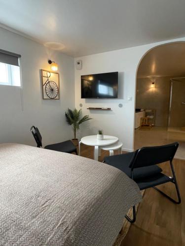 a bedroom with a bed and two chairs and a table at KY Room in Dinsheim