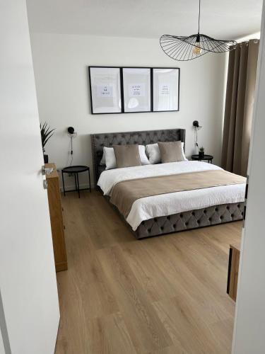 a bedroom with a large bed with wooden floors at Voyage in Kehl am Rhein