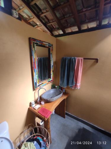 a bathroom with a sink and a mirror at Dune Alaya Ecolodge in Pemuteran