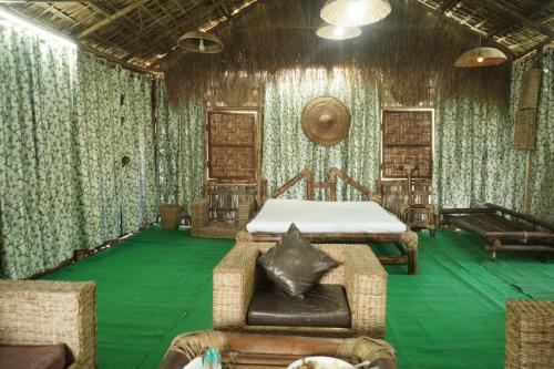 a bedroom with a bed and a green floor at Dhalpur Homestay 
