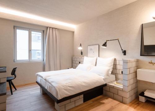 1 dormitorio con 1 cama grande y lavamanos en B5 Boutique Hotel - NEW OPENING, en Lugano