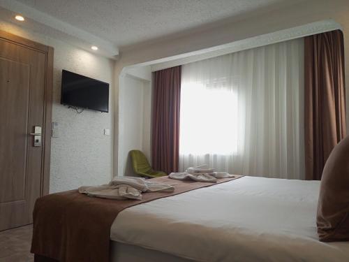 Cama o camas de una habitación en HOTEL GLOBAL 2022