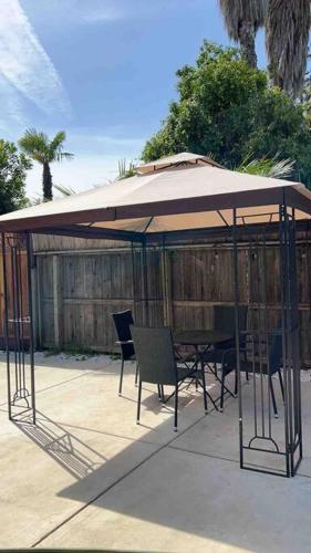 a gazebo with a table and chairs under it at Entire 3 BR & 2 BA house for business and family in Modesto