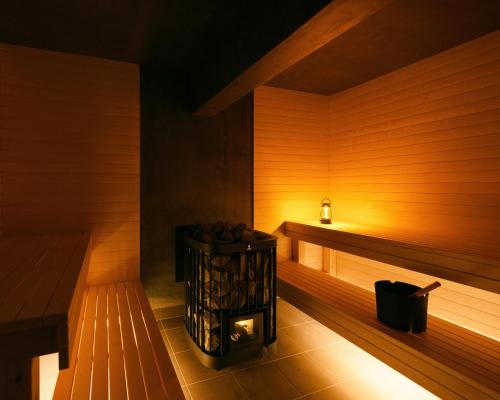 a sauna with a heater in a wooden room at 穴吹邸 / ANABUKI-TEI in Takamatsu