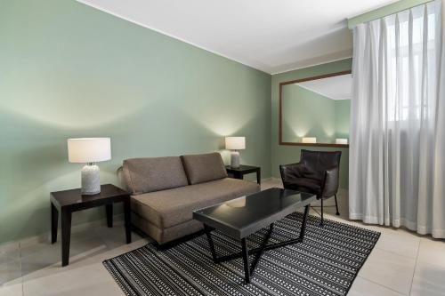 a living room with a couch and a table at Sport Club by Isrotel Collection in Eilat