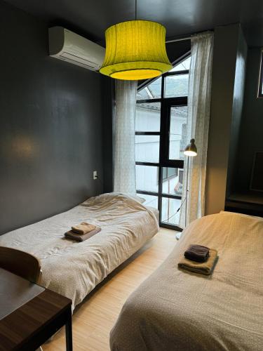 a bedroom with two beds and a large window at Keramiek Arita in Arita