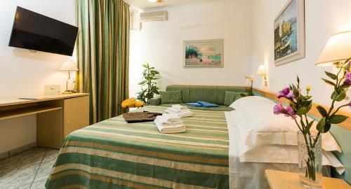 a hotel room with a bed with towels on it at Hotel Bamby in Cervia