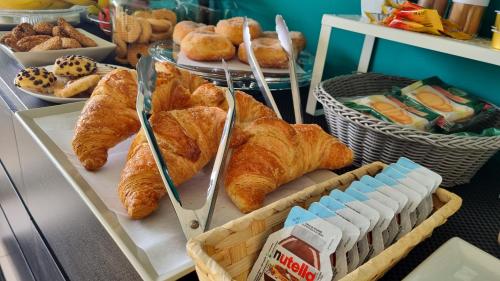 a table with a bunch of croissants and bread at Location10 in Palermo
