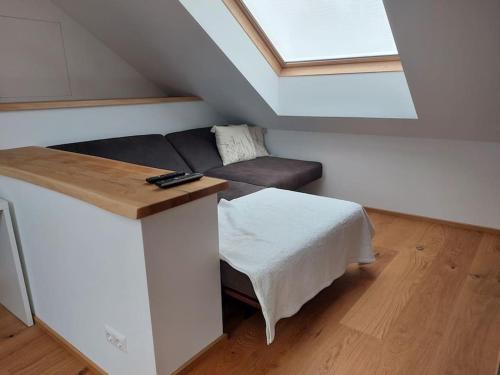 a living room with a couch and a window at Ferienwohnung Goldeckblick in Seeboden