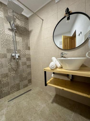 a bathroom with a sink and a mirror at B'LEK SEA RESORT in 2 Mai