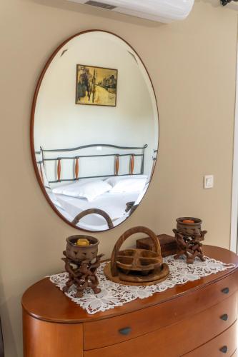 a mirror on top of a dresser in a bedroom at Philip estate in Koiliomenos