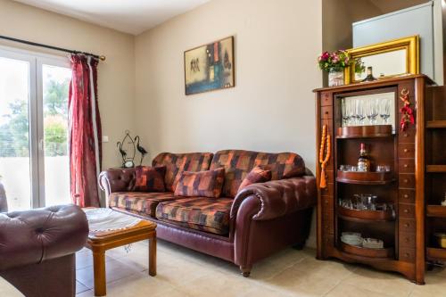 a living room with a couch and a table at Philip estate in Koiliomenos