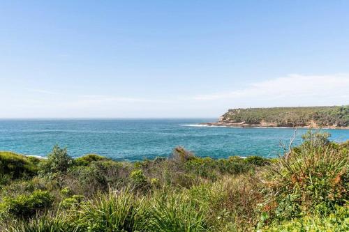 a view of the ocean from a bluff at Merry Beach Getaway in Kioloa