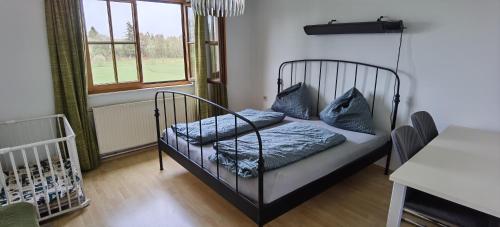 a bed with blue pillows on it in a room at Landhaus auf der Alm 