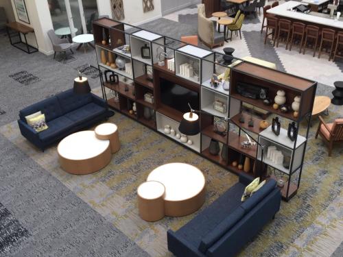 an overhead view of a living room with couches and tables at Holiday Inn Montreal Longueuil by IHG in Longueuil