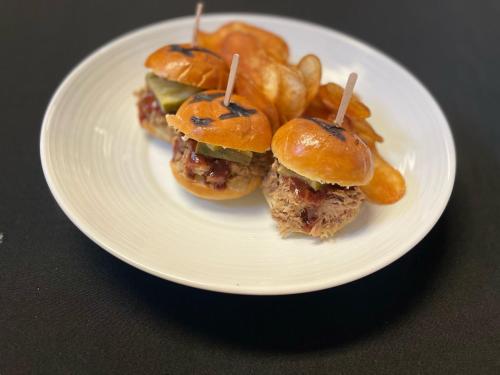 a white plate with three meatballs and french fries at Holiday Inn Montreal Longueuil by IHG in Longueuil