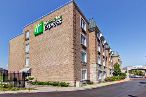 a hotel with a sign on the side of a building at Holiday Inn Express Whitby Oshawa by IHG in Whitby