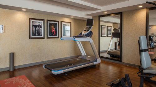 a gym with a treadmill and a mirror at Holiday Inn Winnipeg-South by IHG in Winnipeg