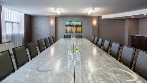 a conference room with a long table and chairs at Holiday Inn Winnipeg-South by IHG in Winnipeg