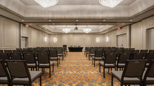a large room with chairs and a podium in it at Holiday Inn Winnipeg-South by IHG in Winnipeg