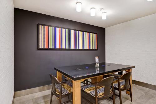 a dining room with a black table and chairs at Holiday Inn Express Whitby Oshawa by IHG in Whitby