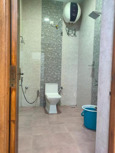a bathroom with a toilet and a shower and a camera at REGALIA ROOMS KODAI in Kodaikānāl